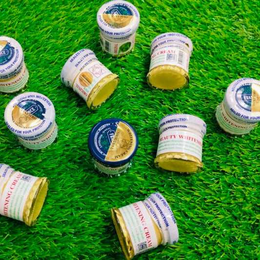 Multiple jars of cream with visible labels on a green grass background