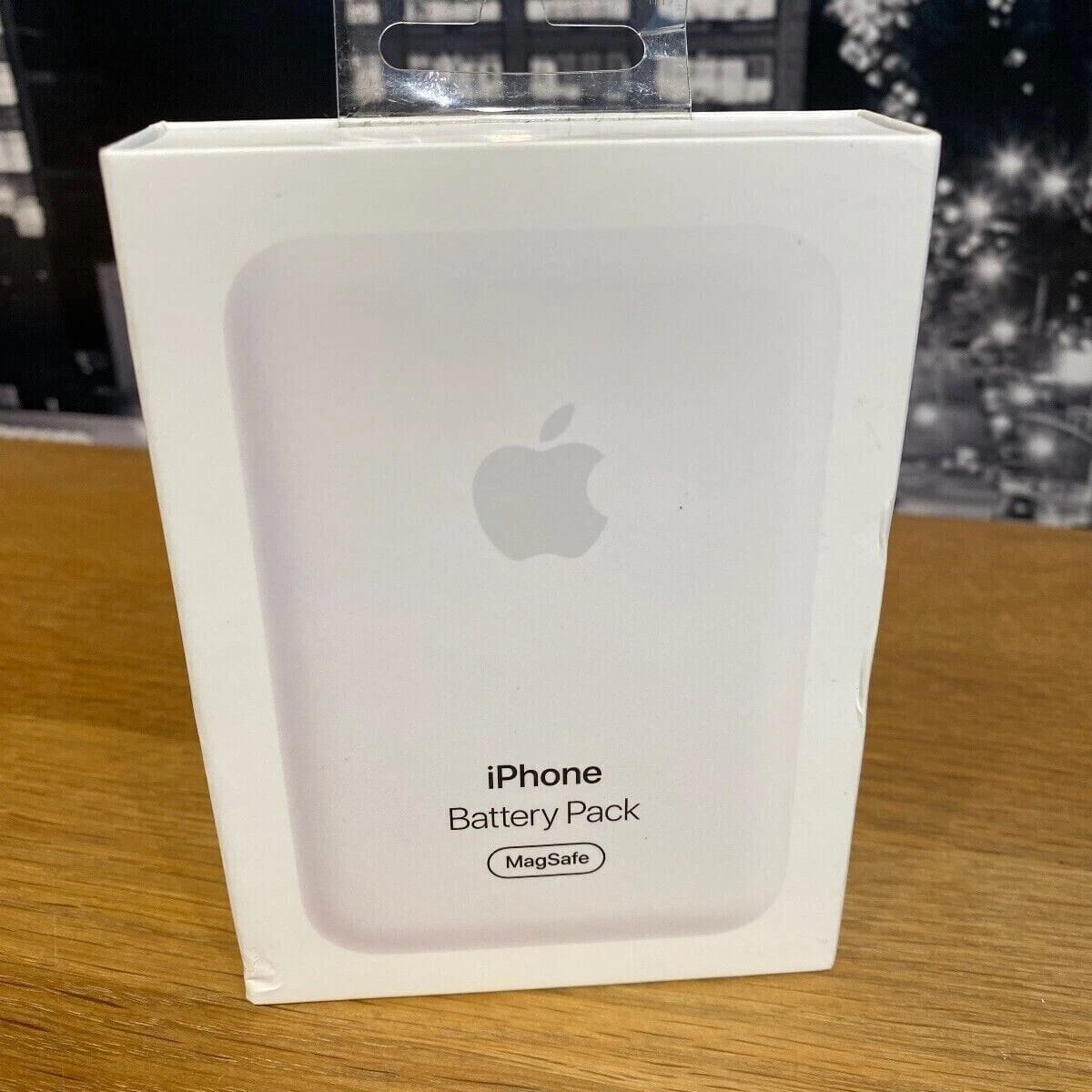 White iPhone Battery Pack  on a wooden surface