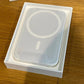 White phone case in a box on a wooden surface
