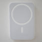 White wireless charging pad on a light gray background