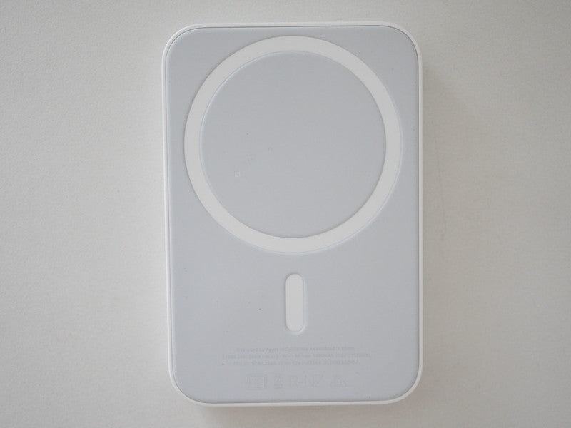 White wireless charging pad on a light gray background
