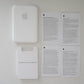 White Apple product with Apple logo and text on a white background