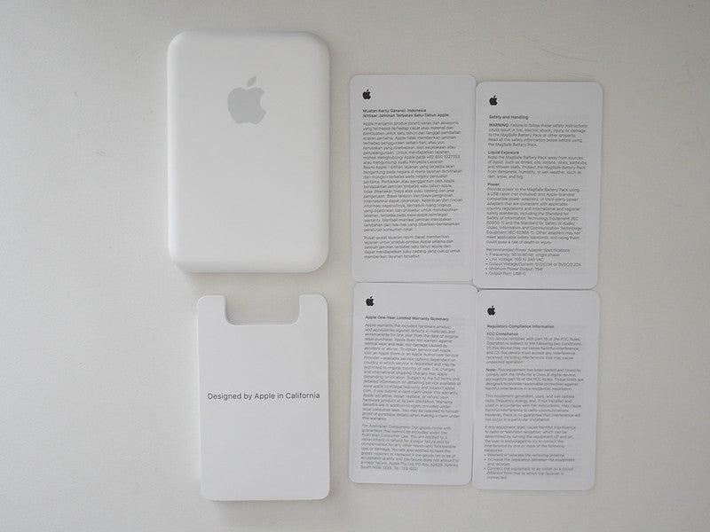 White Apple product with Apple logo and text on a white background